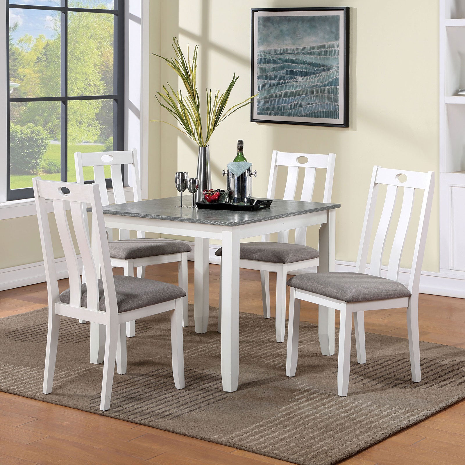 White dining chairs with grey upholstered seats around a square table