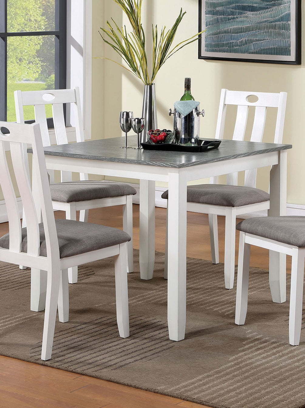 White wooden dining chairs with grey upholstered seats around a square stonetop table