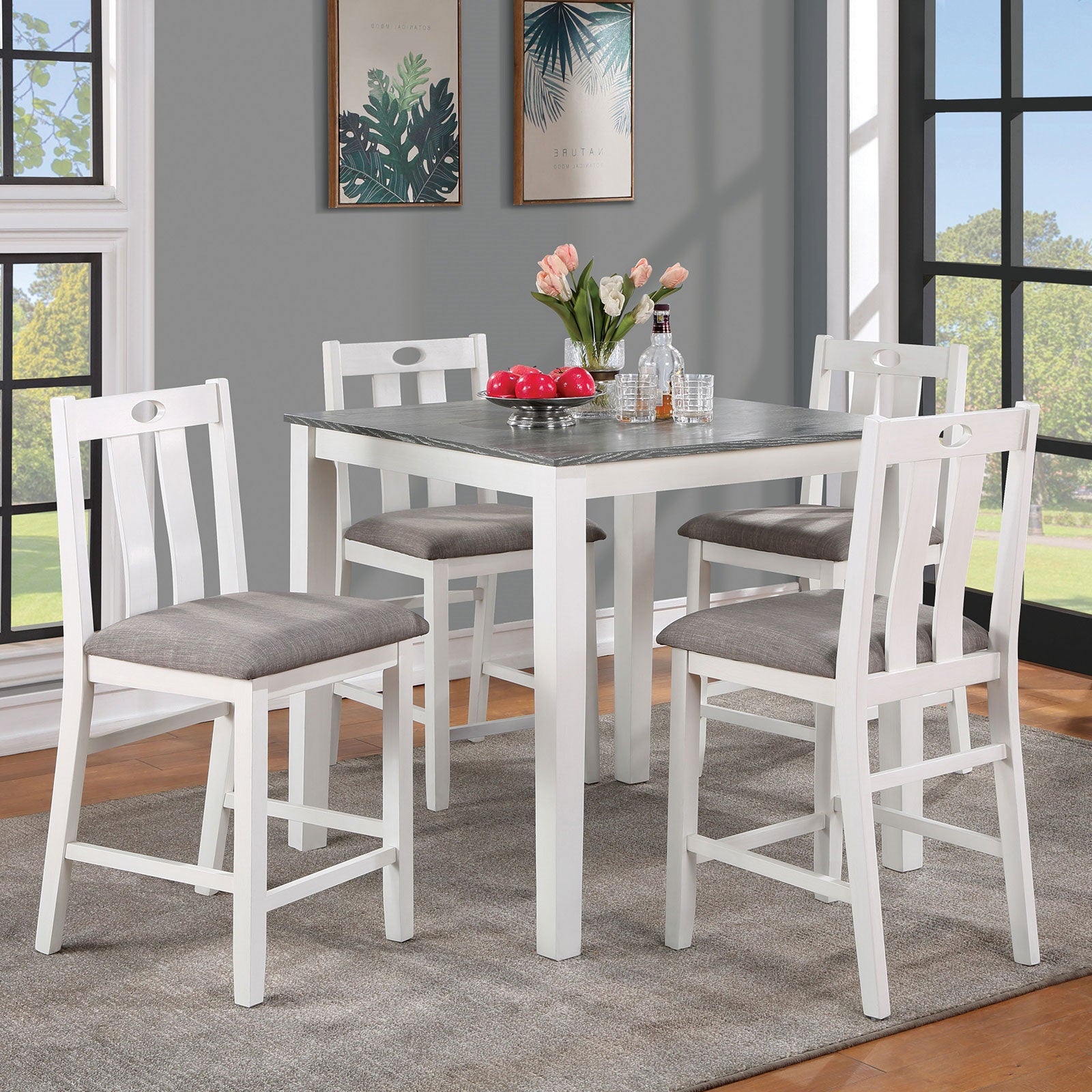 White wood counter height table and four chairs with grey upholstered seats