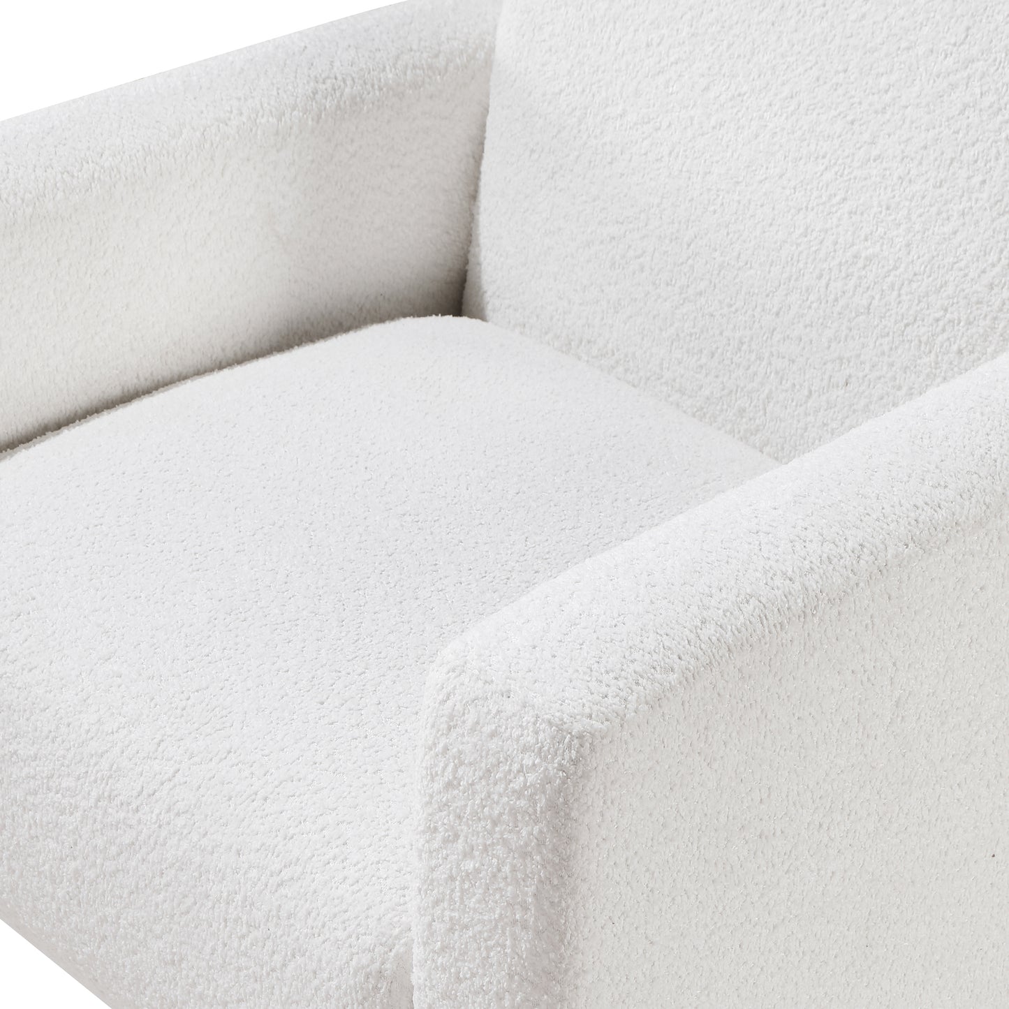 Closeup of a plush white boucle armchair seat and armrest