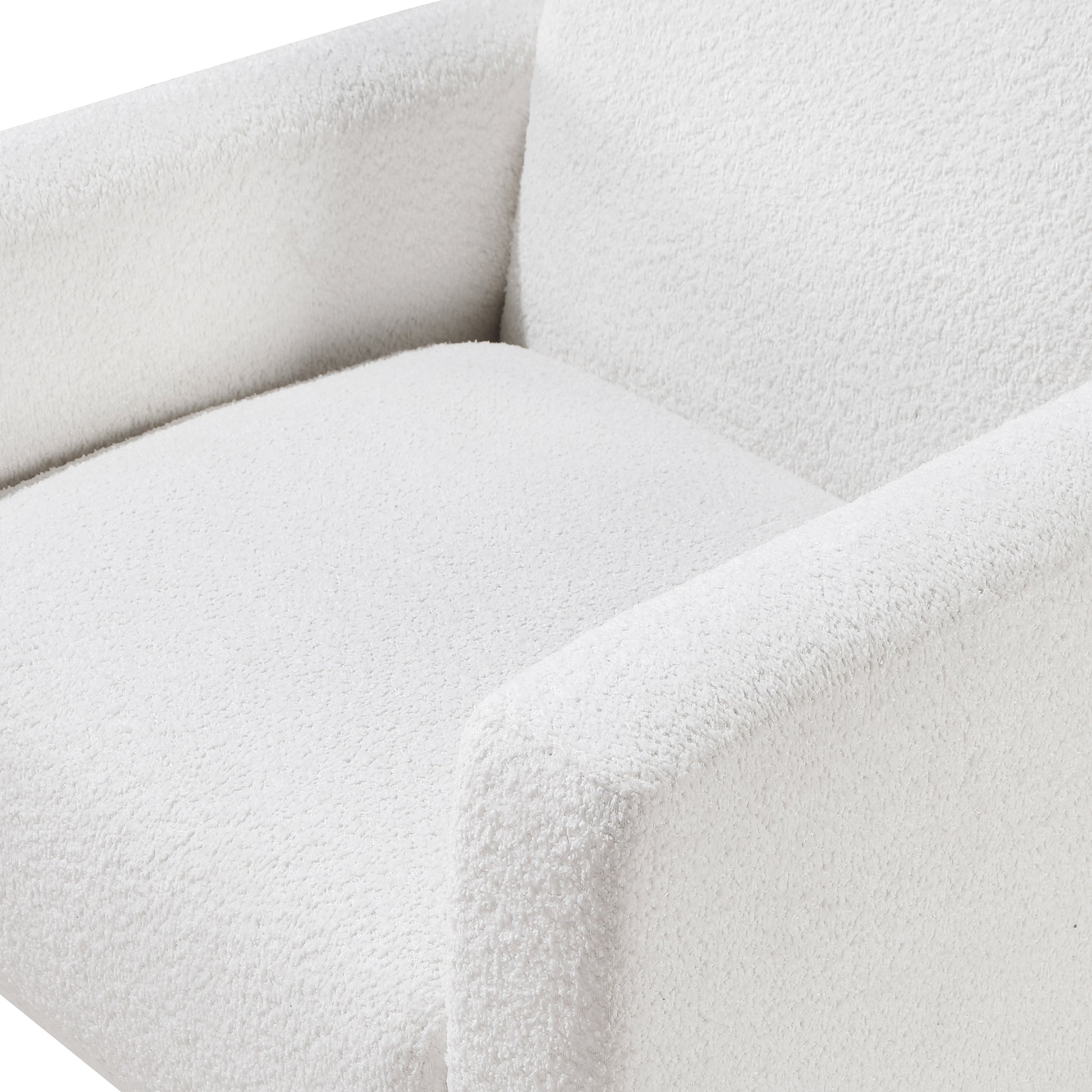 Closeup of a plush white boucle armchair seat and armrest