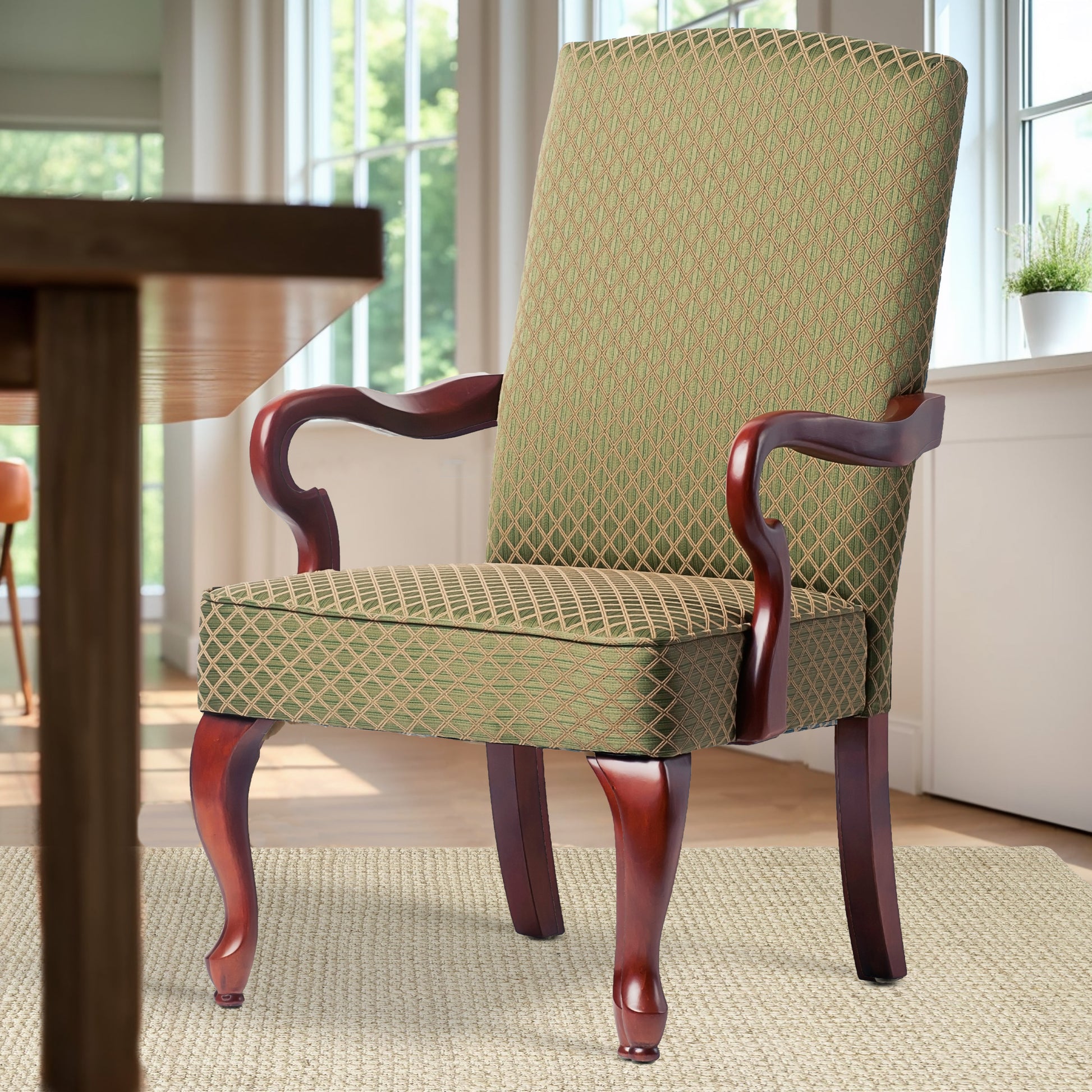 Elegant upholstered dining chair in green diamond pattern fabric with dark wood frame and cabriole legs