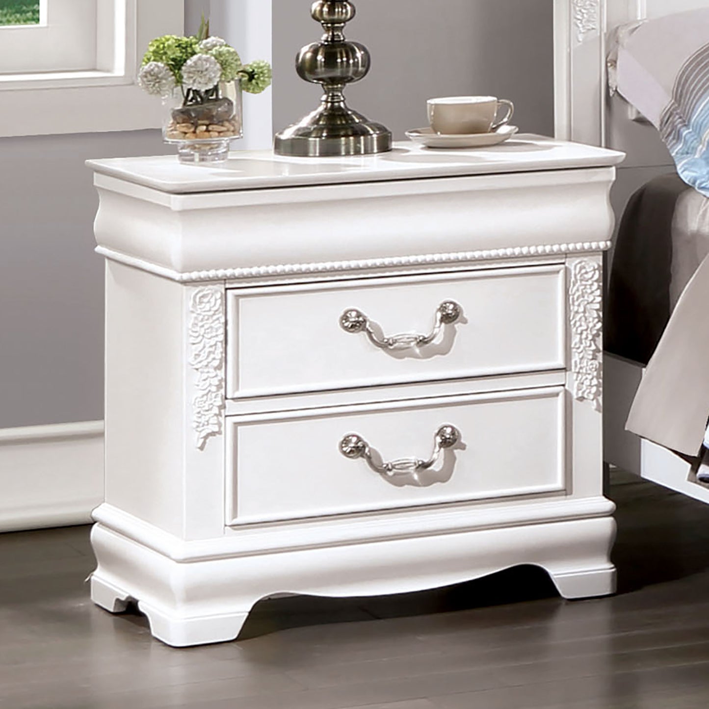 White wooden nightstand with ornate floral carving and two drawers