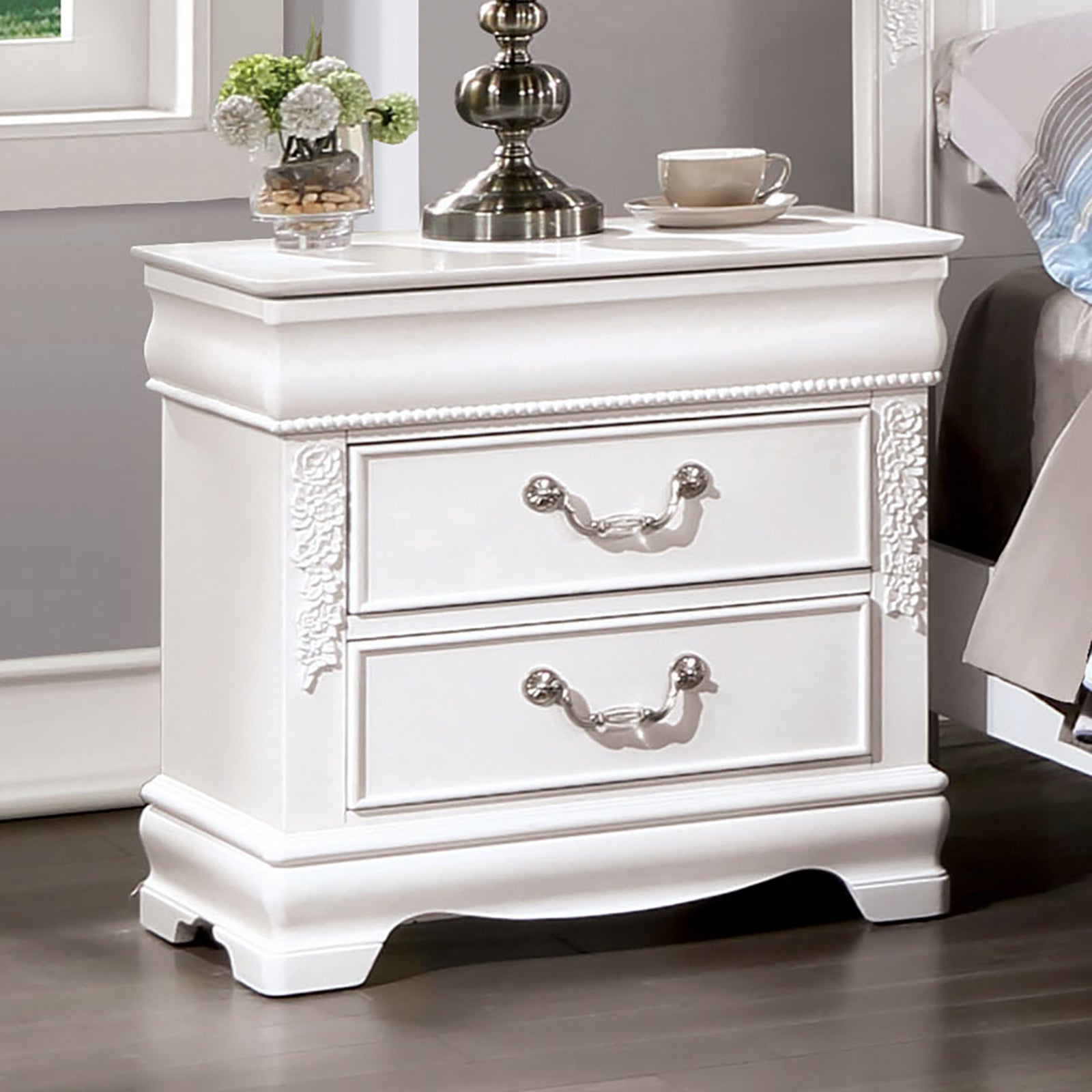 White wooden nightstand with ornate floral carving and two drawers