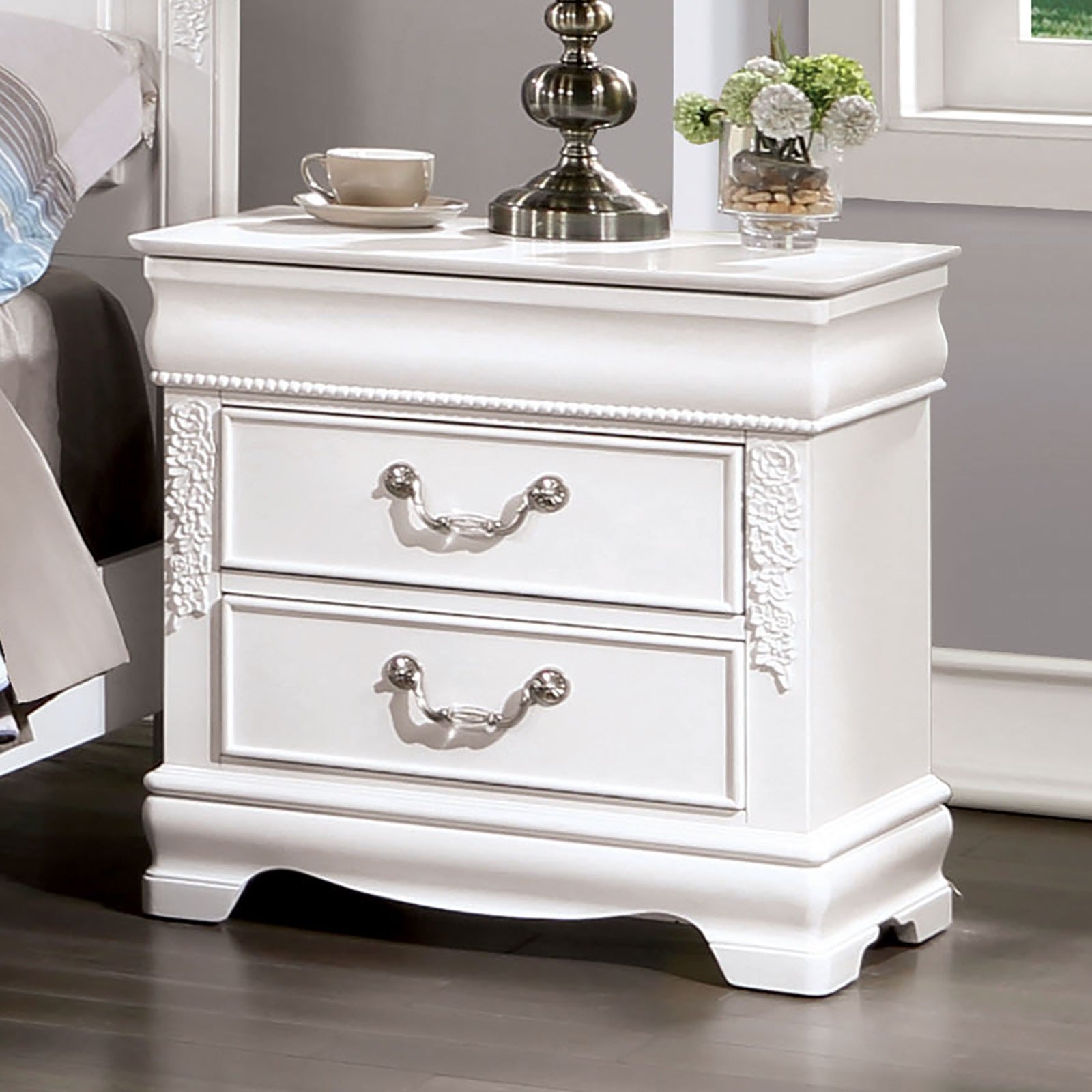 White ornate nightstand with two drawers and antique silver pulls for bedroom storage