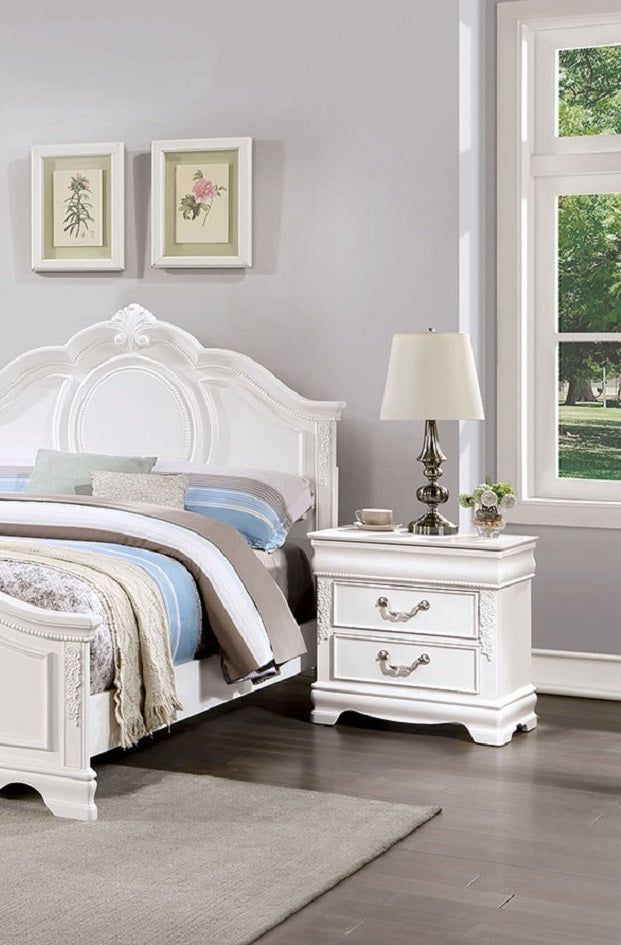 Ornate white wood bedside table with two drawers and antique brass hardware