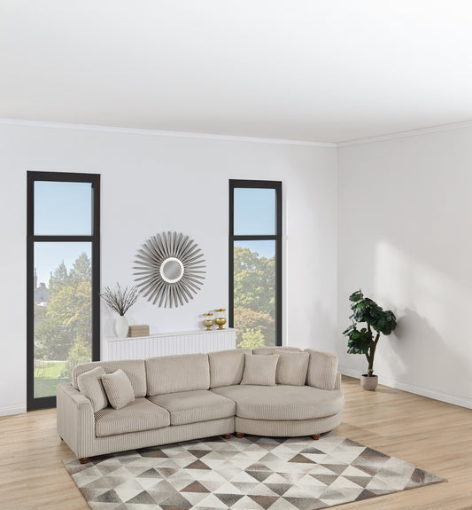 Sectional sofa in light beige corduroy with curved arm and accent pillows