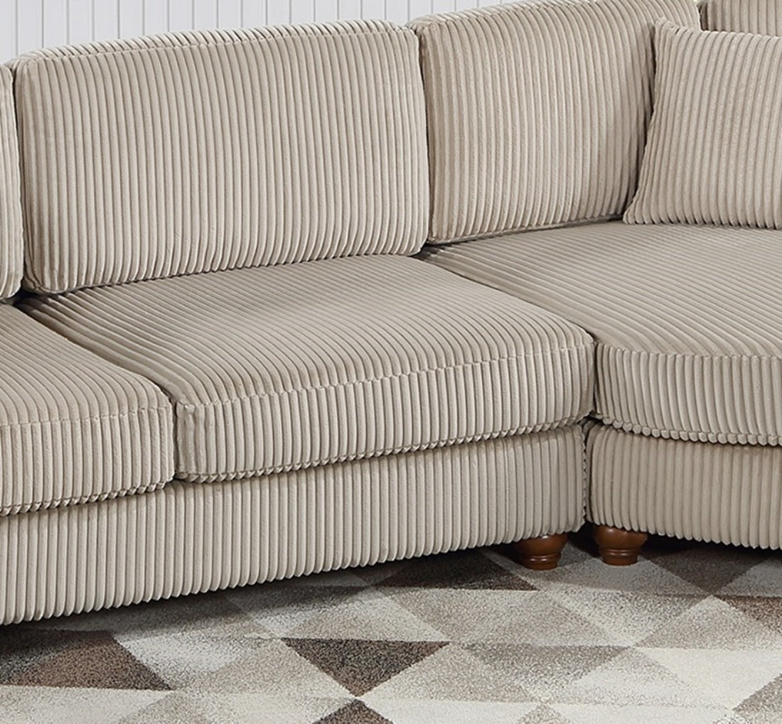 Closeup of plush beige corduroy sectional sofa cushions and armrest