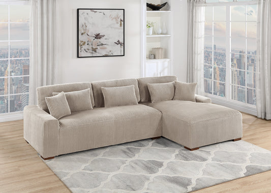 Beige corduroy sectional sofa with plush throw pillows on a grey patterned rug