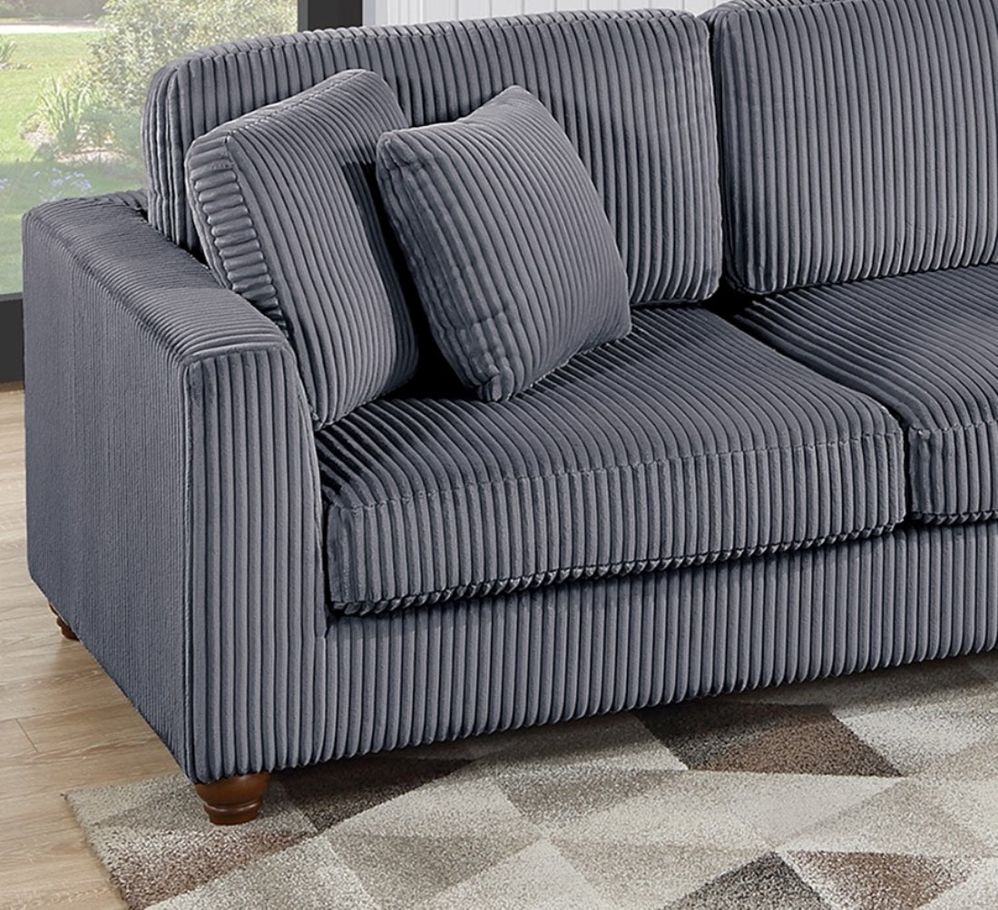 Gray corduroy sofa with textured fabric and two matching throw pillows