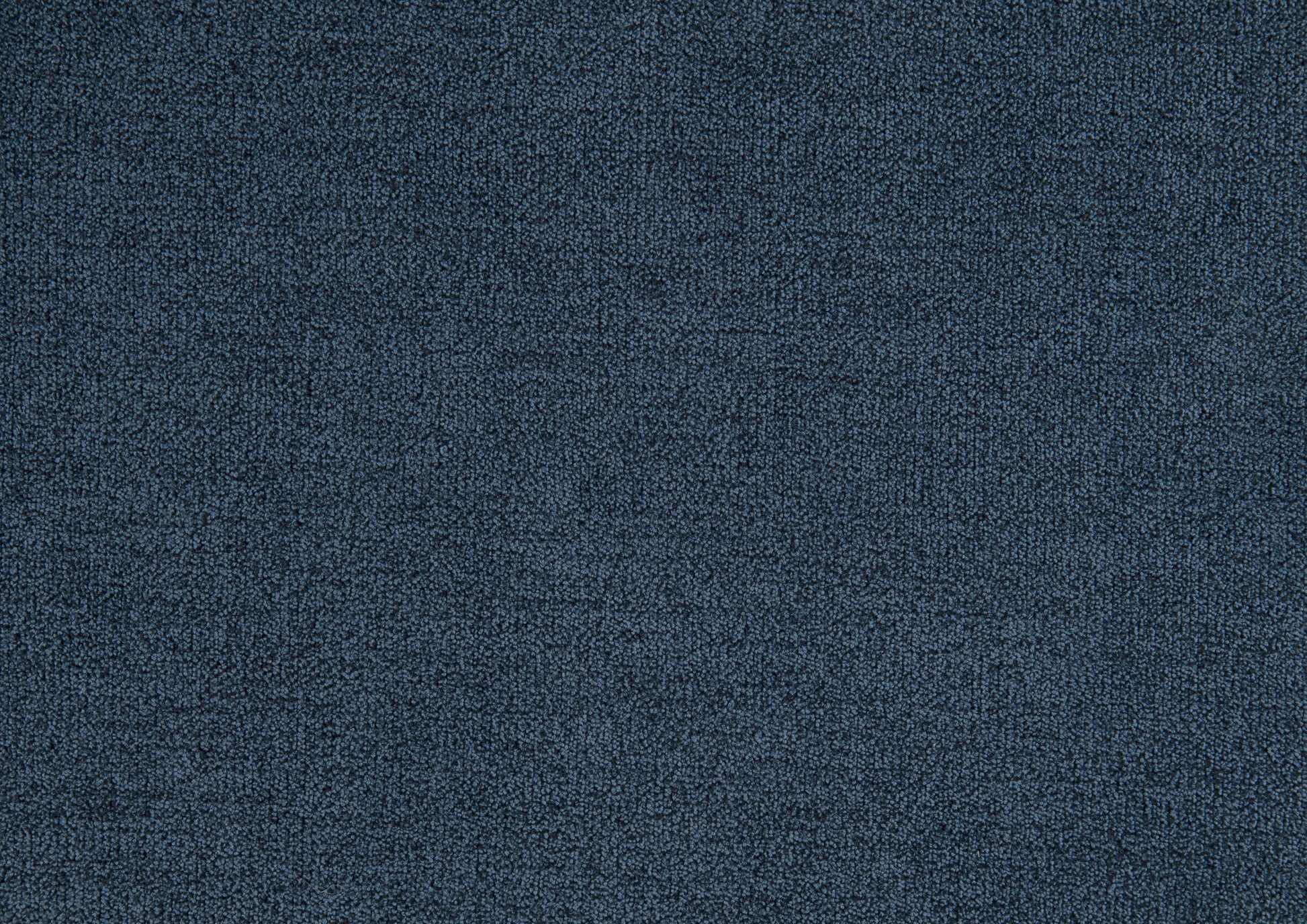 Closeup of textured navy blue carpet with short dense fibers