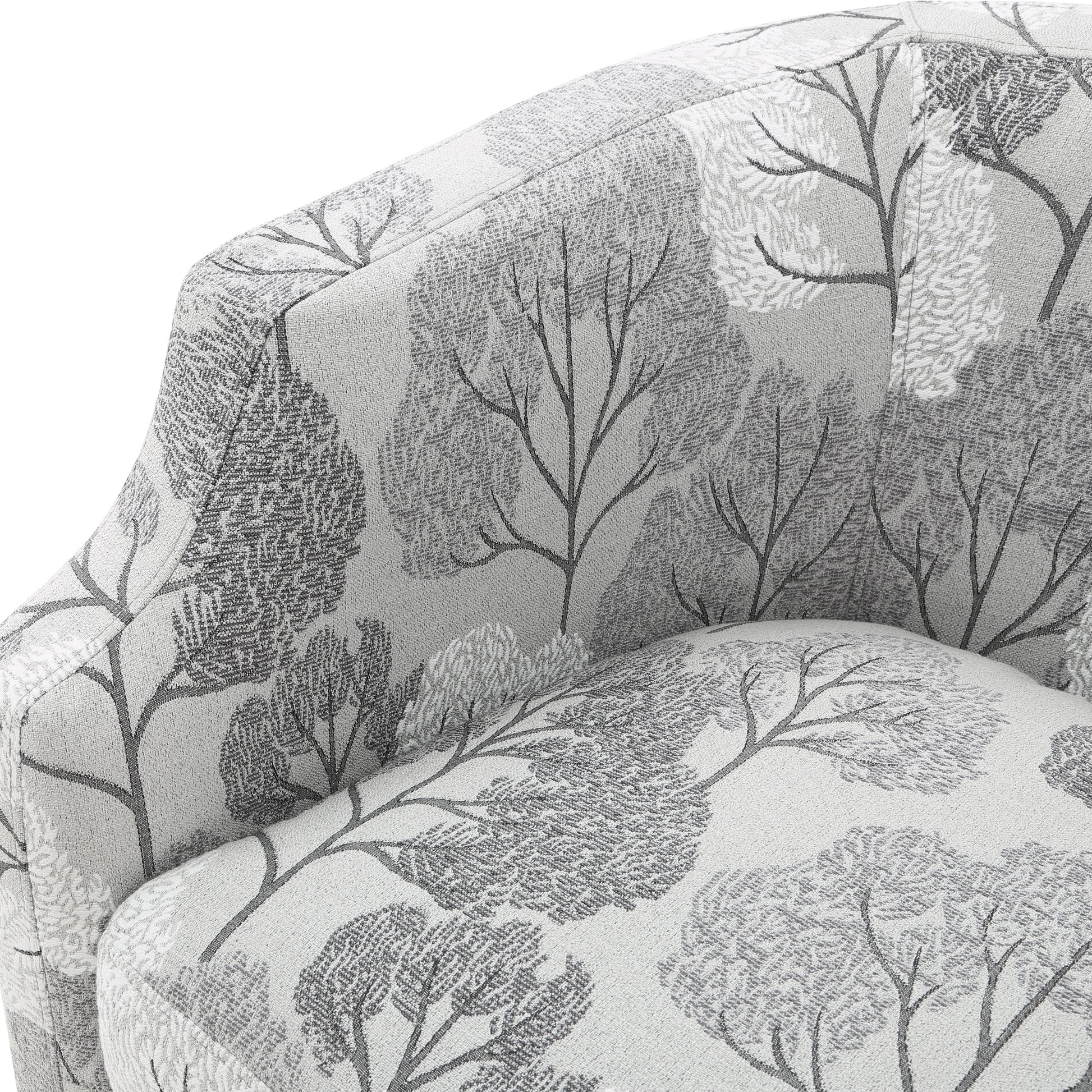 Grey upholstered accent chair with a grey and white tree pattern fabric