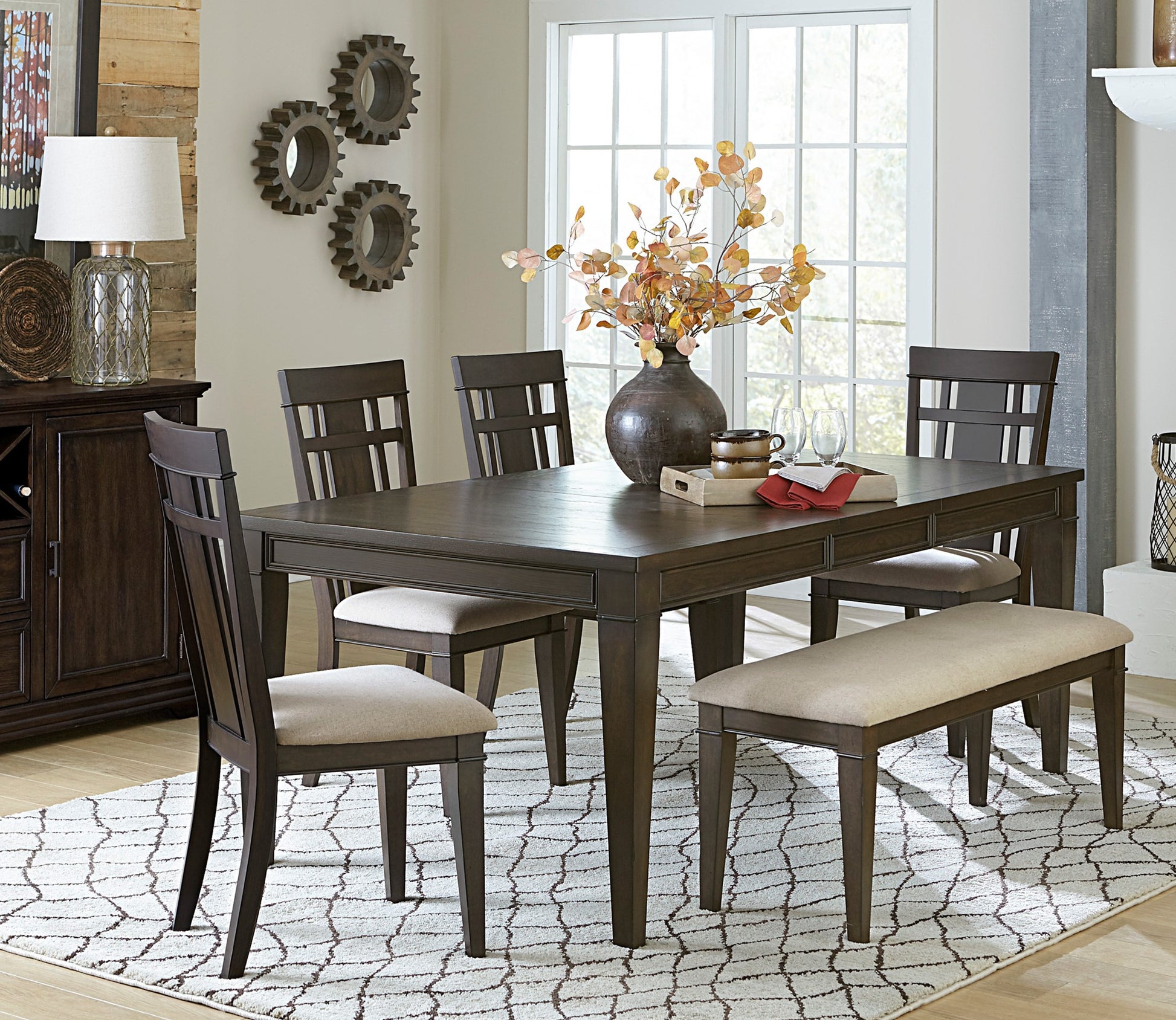Dark wood dining table with upholstered chairs and bench perfect for family meals