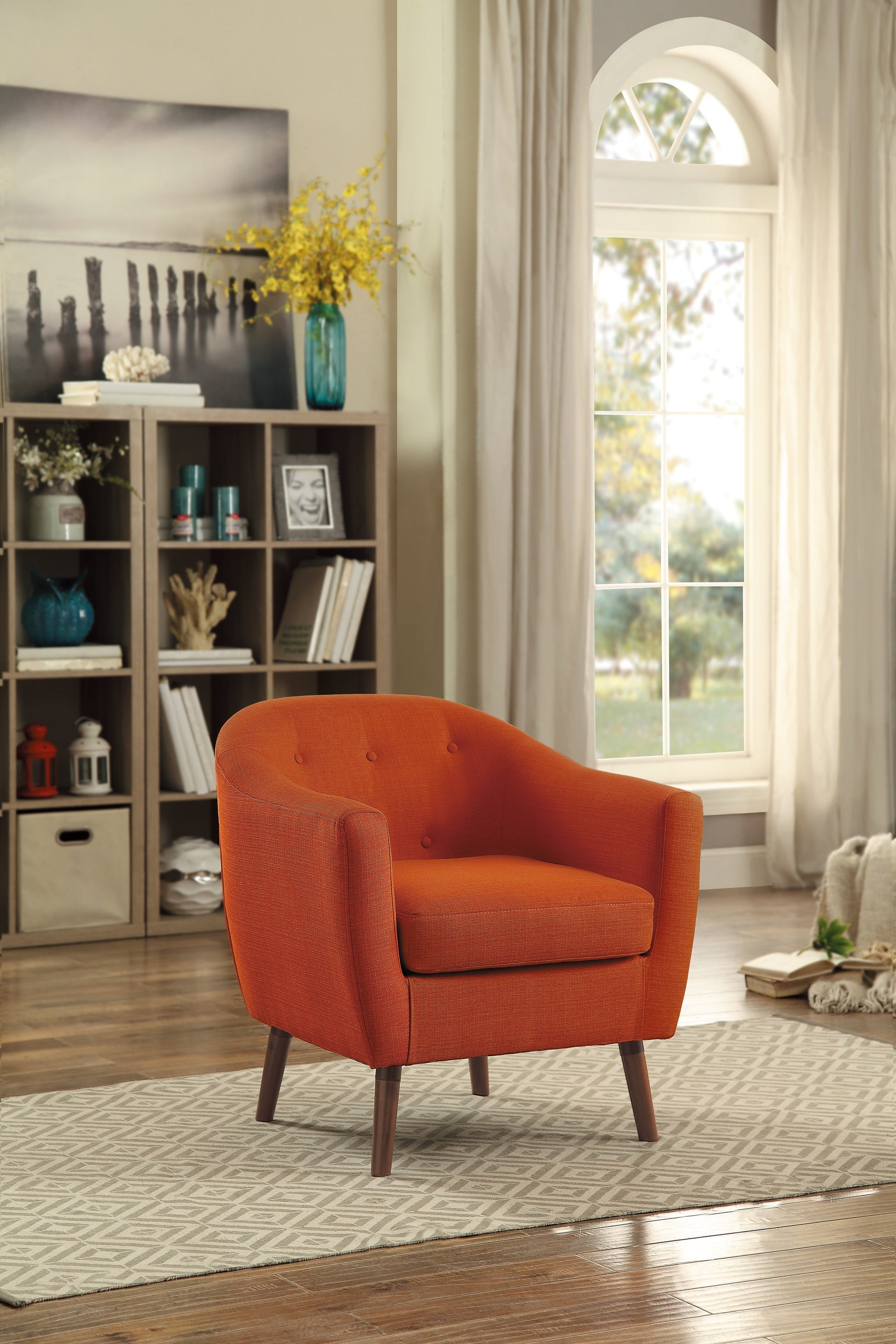 Orange upholstered accent chair with button tufting and tapered wooden legs