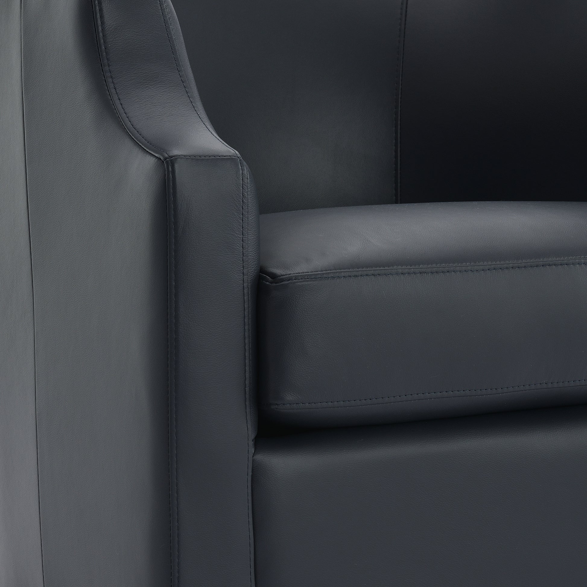 Closeup of a dark grey leather accent chair showing stitching and texture