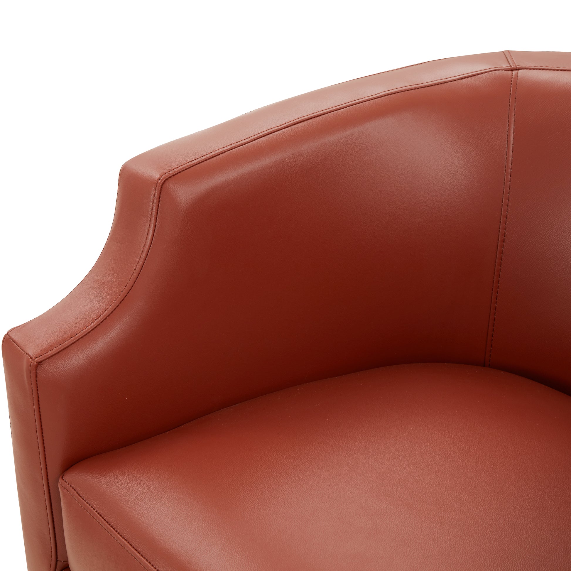 Closeup of a brown leather armchair seat and armrest with visible stitching