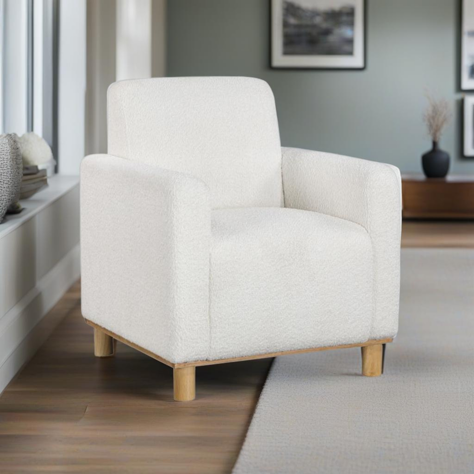 Plush white boucle armchair with natural wood legs perfect for a cozy living room