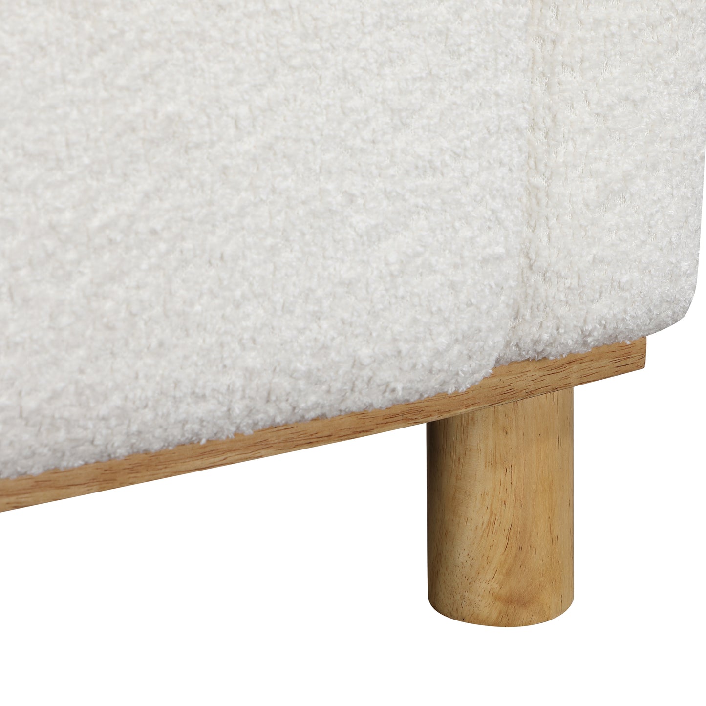 Closeup of textured white sherpa fabric on a woodenlegged ottoman perfect for cozy living rooms