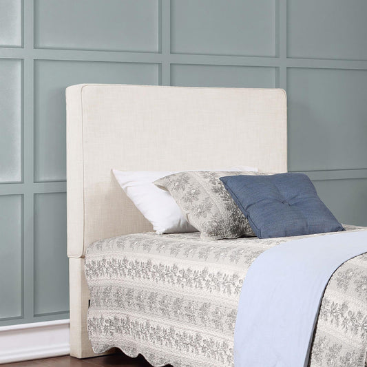 Upholstered headboard with linen fabric in a neutral beige for a cozy bedroom