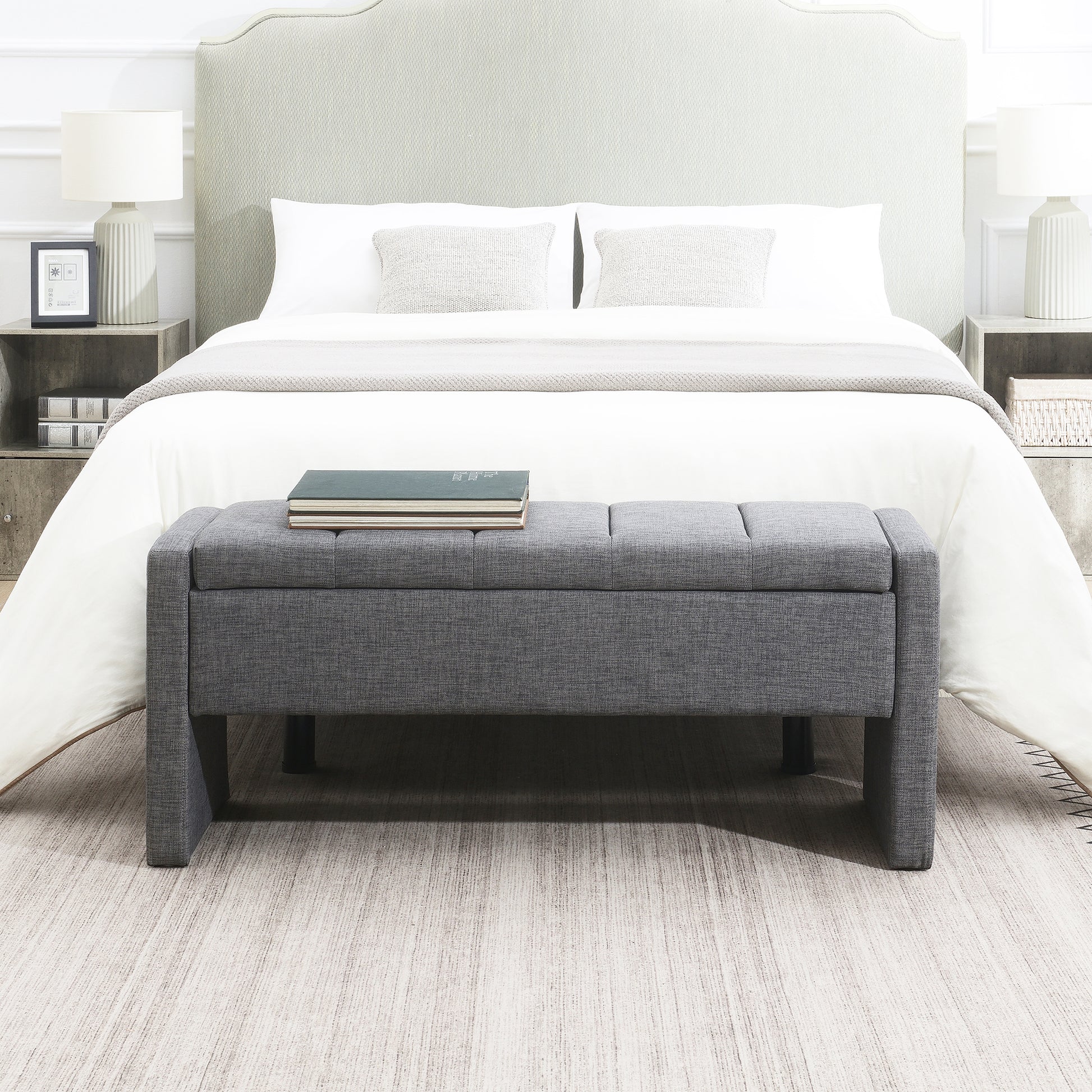 Tufted grey fabric storage bench with upholstered top providing bedroom seating and storage