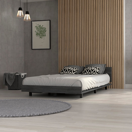 Dark gray wood platform bed with white linens and geometric pillows