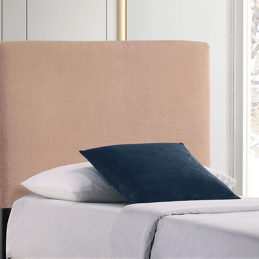 Blush pink velvet upholstered headboard with clean lines adding a soft touch to the bedroom