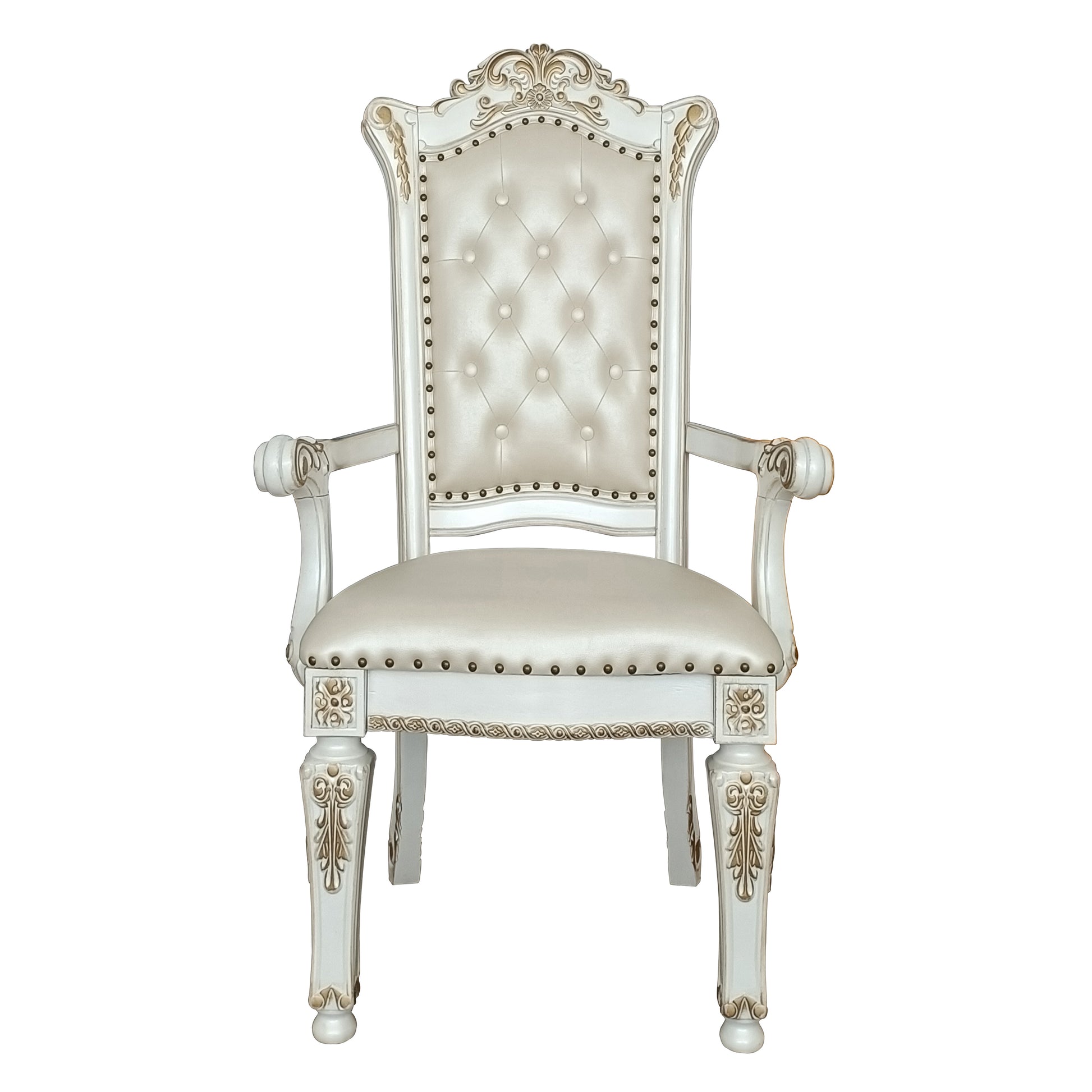 Elegant tufted cream armchair with ornate gold accents and nailhead trim