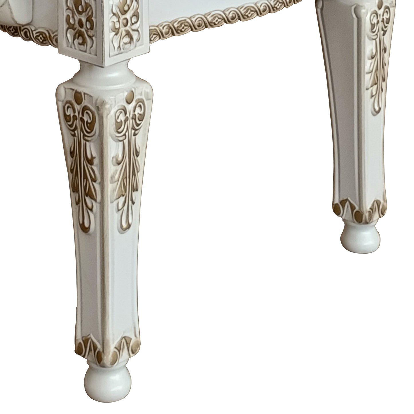 Ornate white carved table legs with gold accents