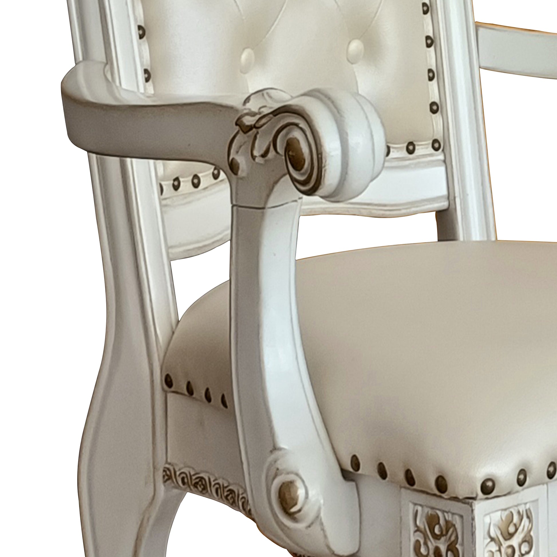Ornate white armchair with tufted cream upholstery and carved wooden armrests for living room