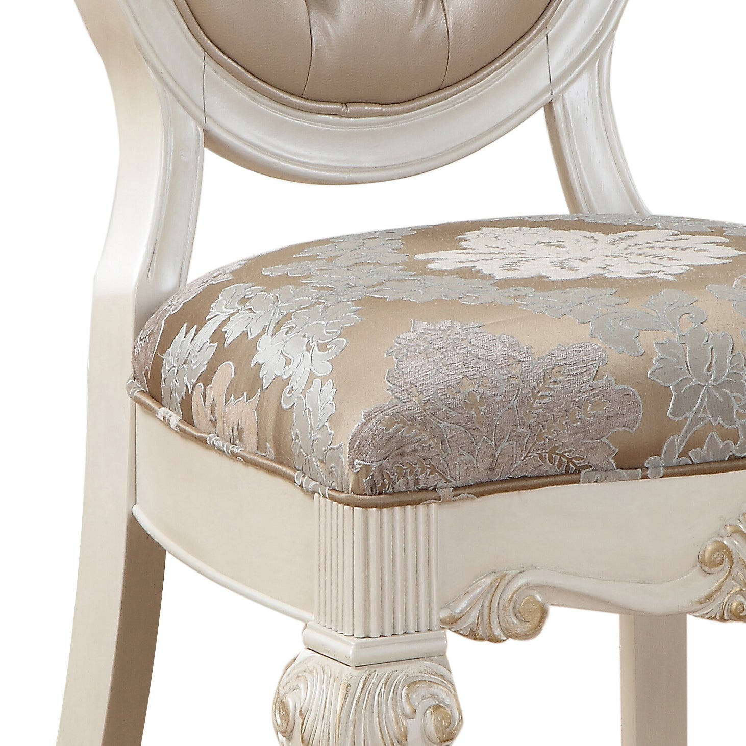 Ornate carved wooden accent chair with a patterned fabric seat and tufted leather back