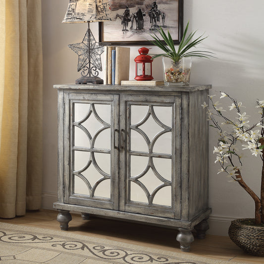 Distressed gray accent cabinet with mirrored geometric doors and decorative legs