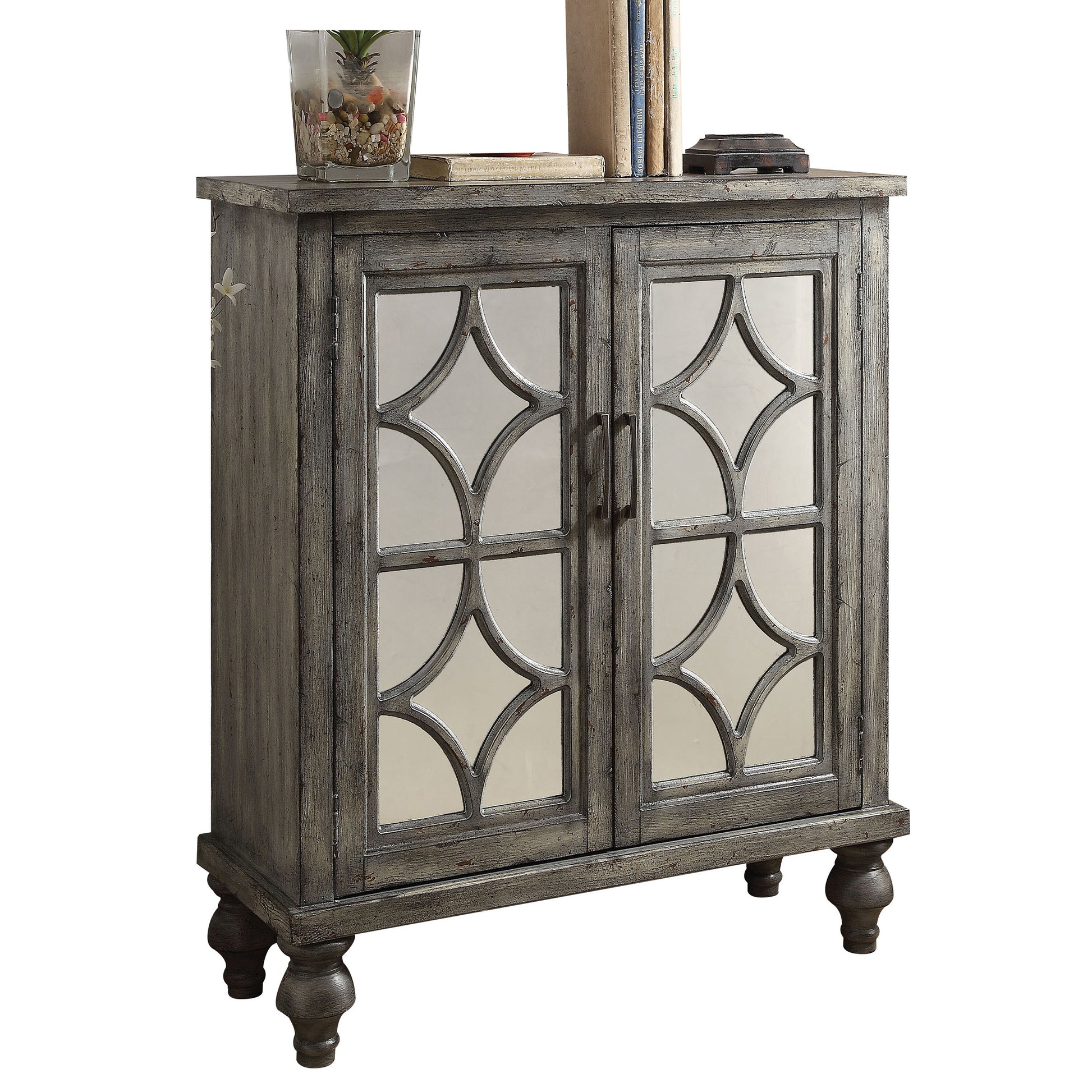 Distressed gray cabinet with mirrored quatrefoil glass doors and decorative carved legs