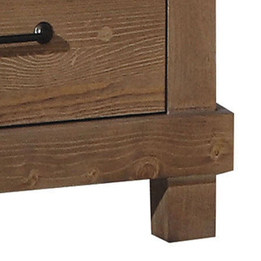 Distressed wood drawer front with black knob on rustic pine dresser