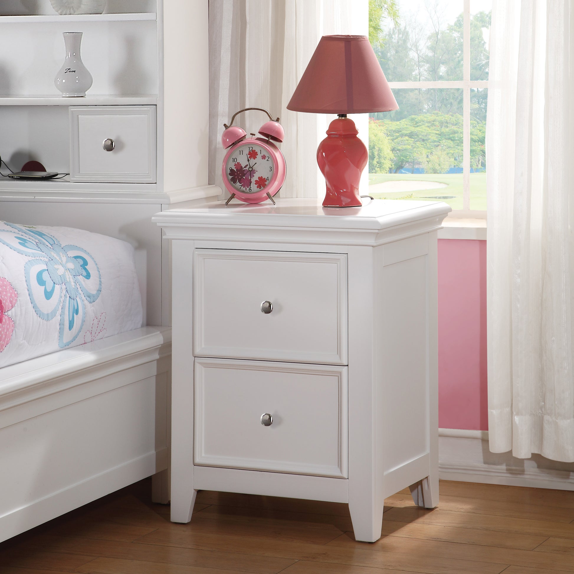 White wooden nightstand with two drawers featuring silver knobs and decorative molding