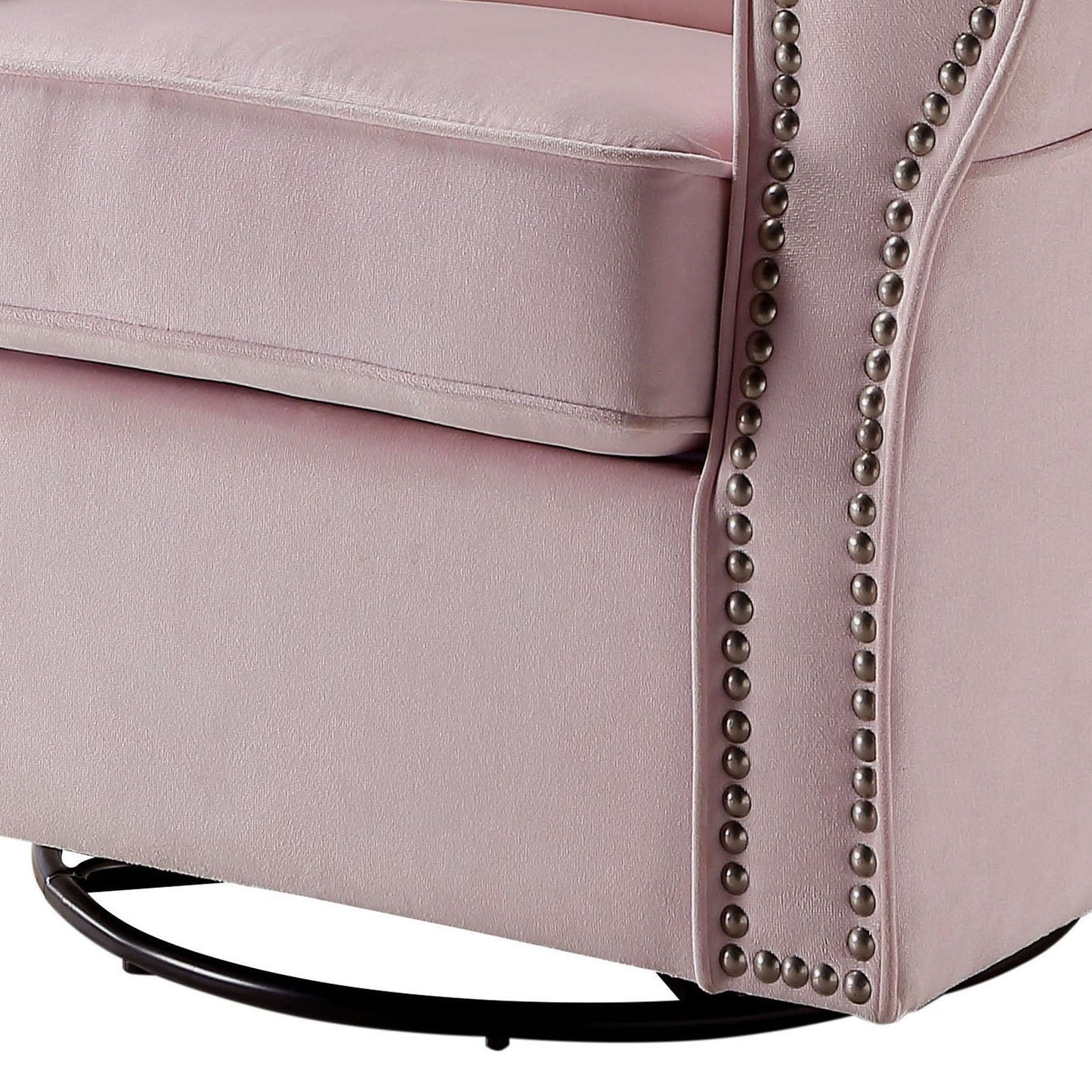 Closeup of a plush pink velvet armchair with decorative nailhead trim