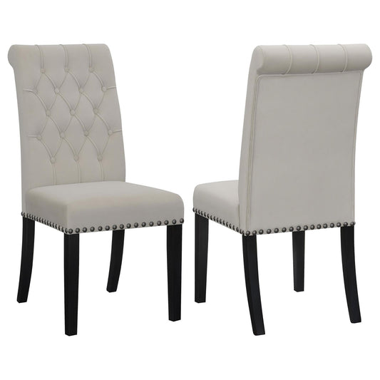 Light beige velvet dining chair with tufted back and silver nailhead trim
