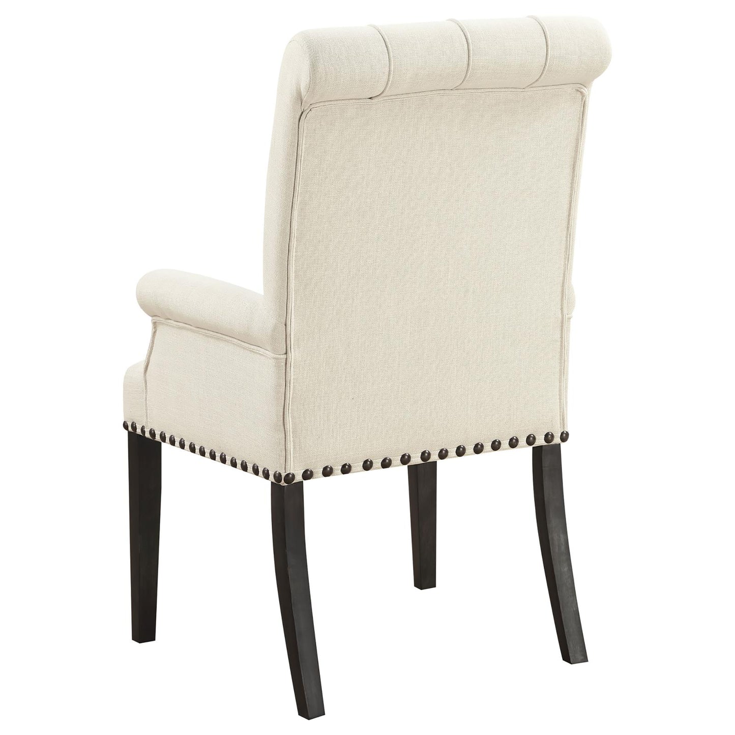 Upholstered beige tufted dining chair with dark wood legs and decorative nailhead trim