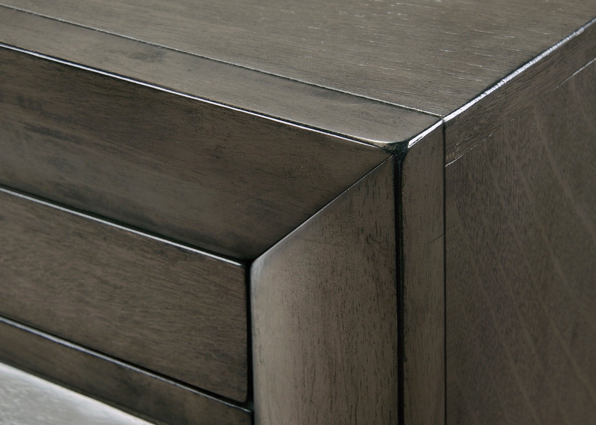 Dark gray wood grain dresser drawer front with a clean modern design and subtle sheen