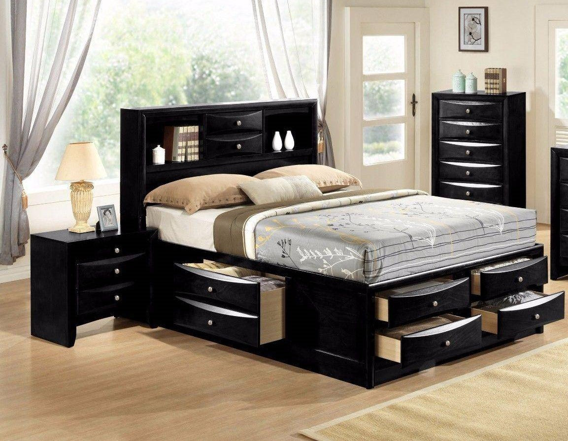 Black storage bed with open drawers and a bookcase headboard in a modern bedroom