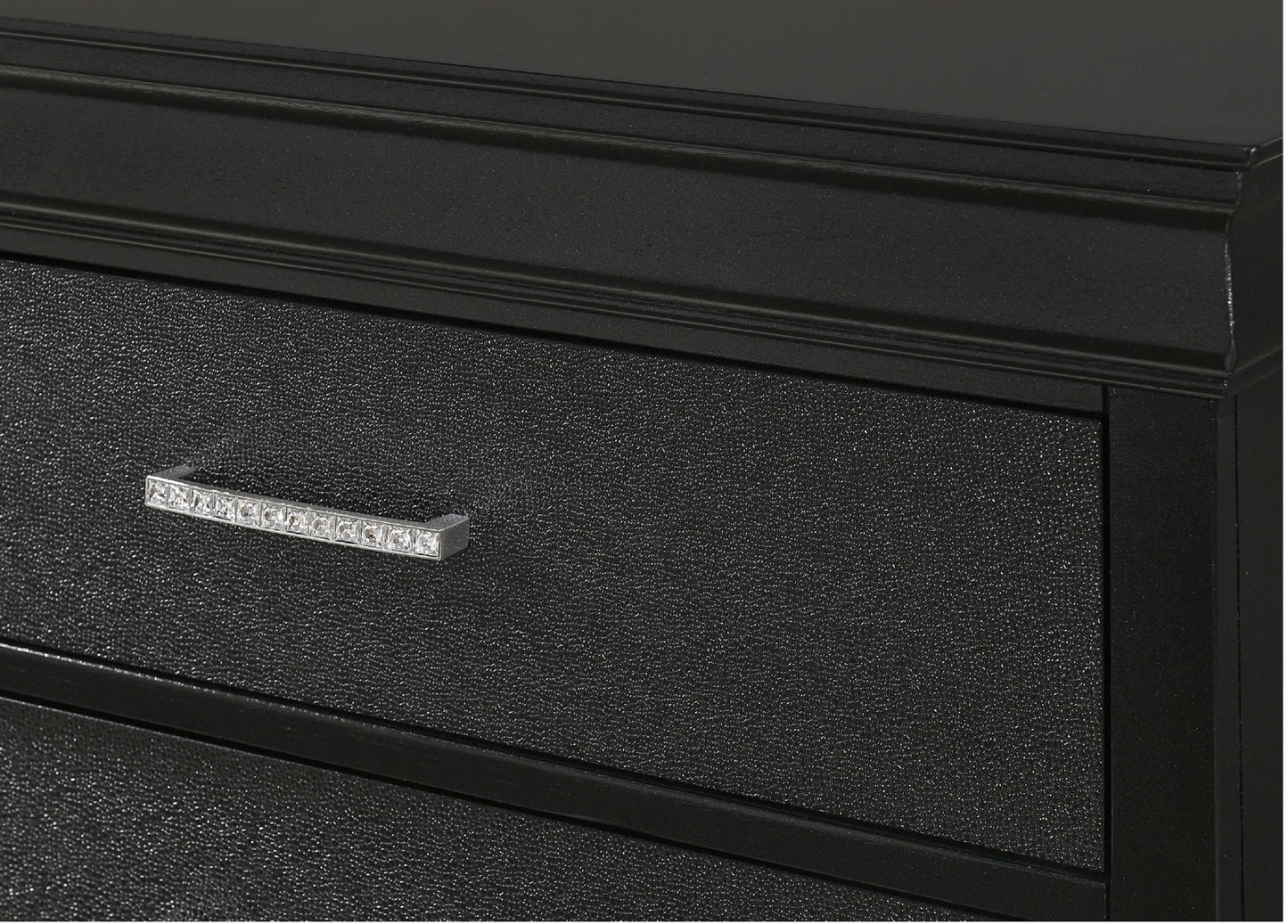 Closeup of a black dresser drawer with a textured finish and a silver handle adorned with small crystals