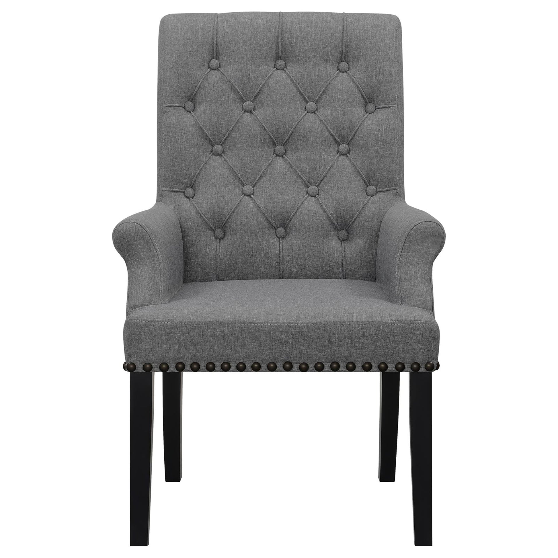 Tufted grey fabric armchair with button accents and brass nailhead trim on black legs
