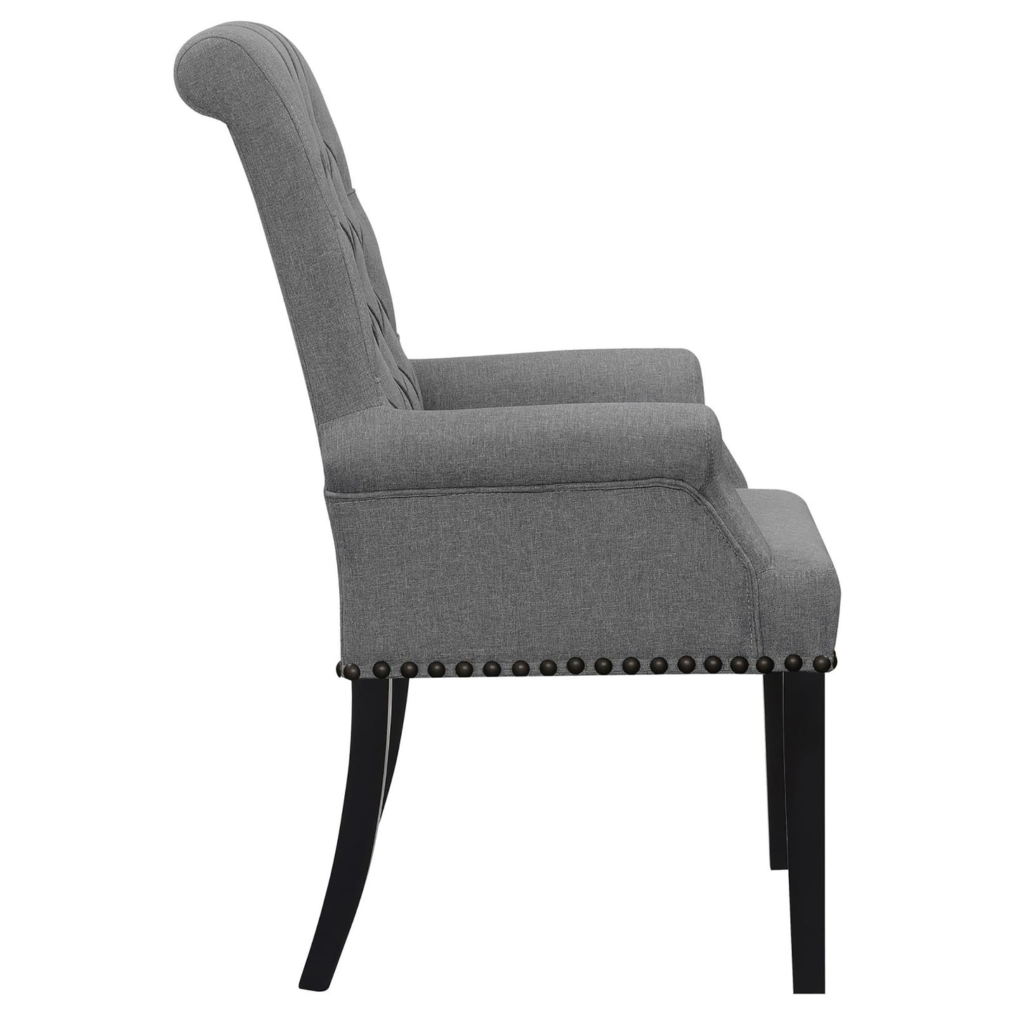 Grey upholstered armchair with tufted back and nailhead trim