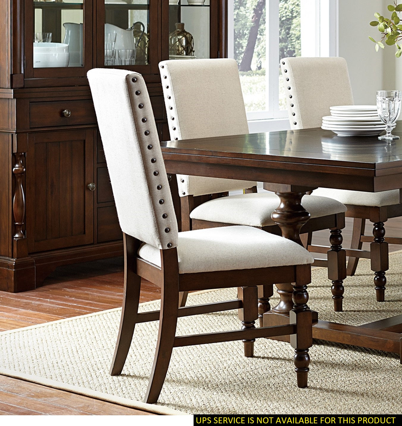 Upholstered dining chair with nailhead trim and light beige fabric seat