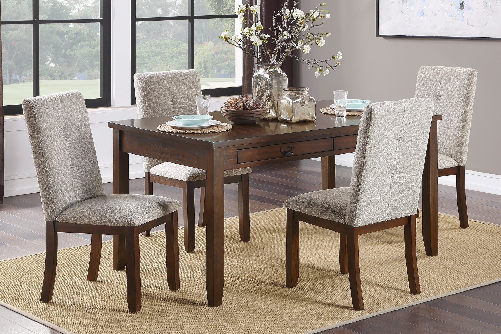 Dark wood dining table with tufted upholstered chairs set for four