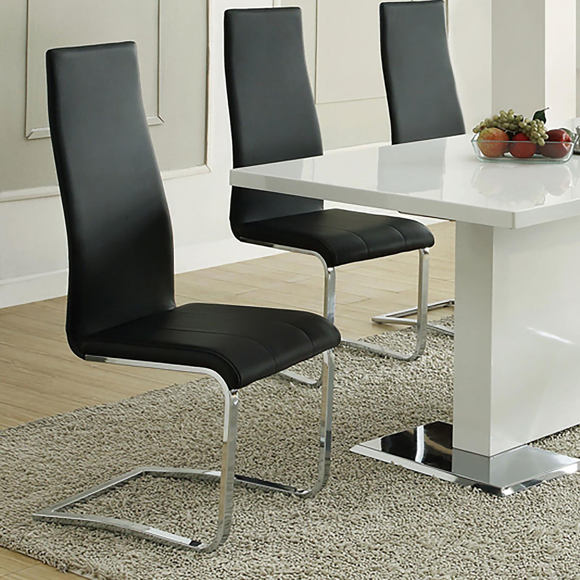 Modern black faux leather dining chairs with sleek chrome sled legs