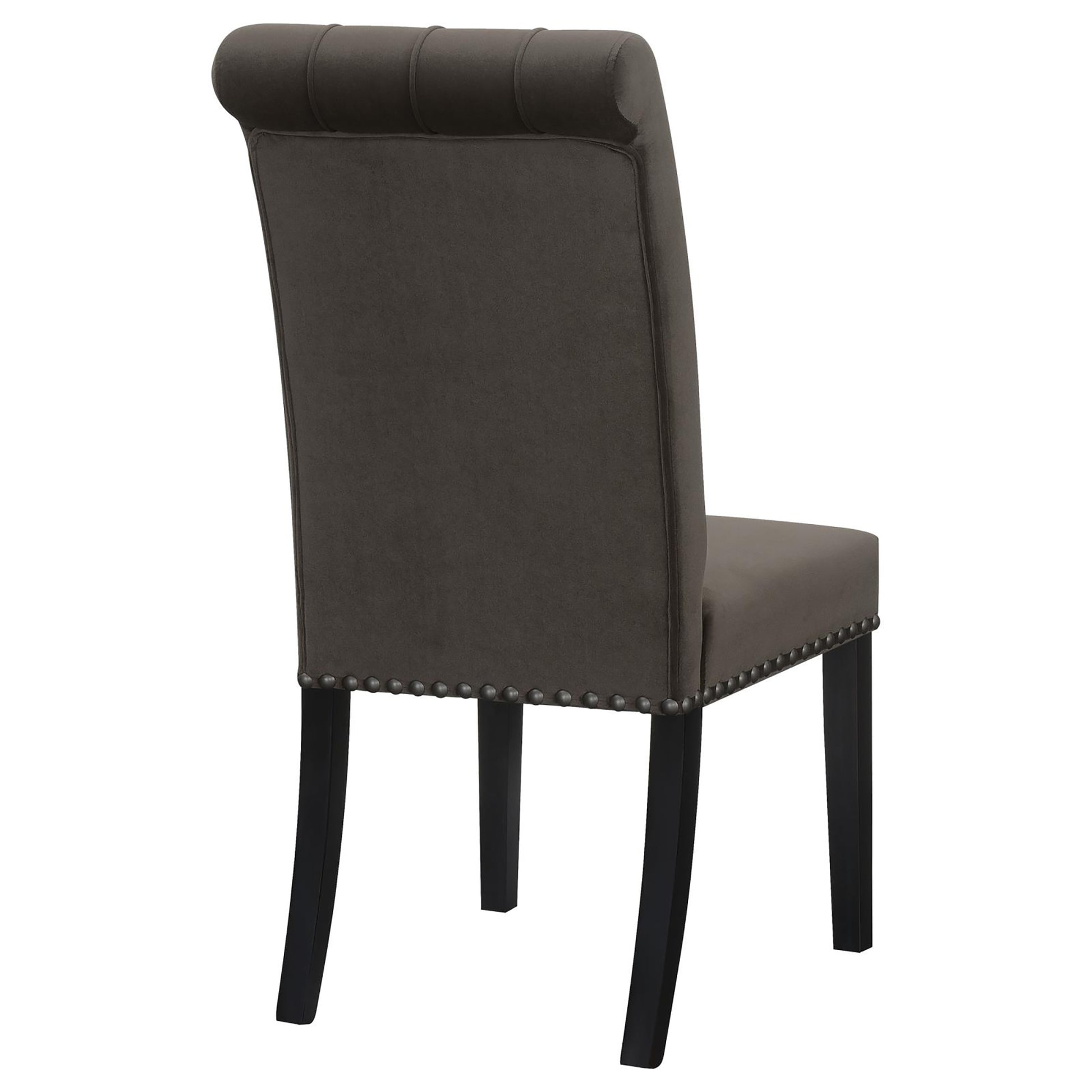 Tufted charcoal gray velvet dining chair with nailhead trim and dark wood legs