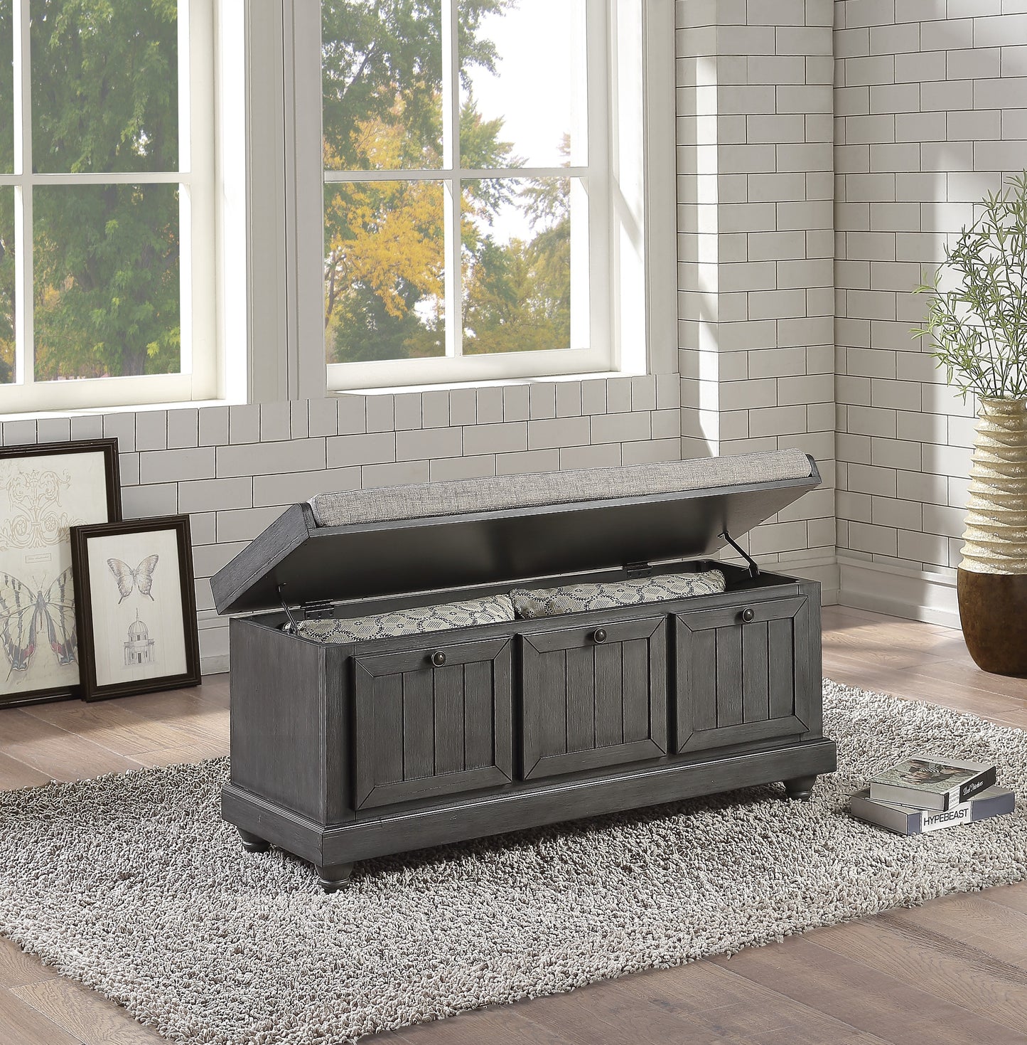 Gray wooden storage bench with upholstered lid and ornate patterned interior perfect for entryways