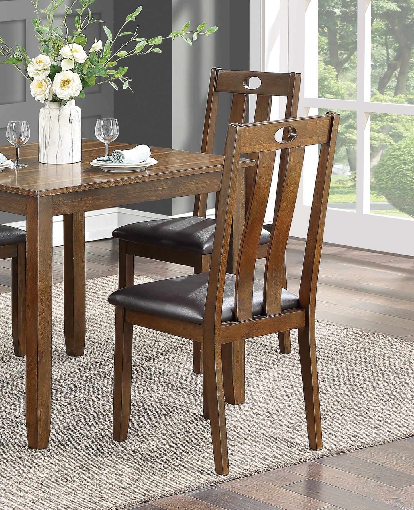 Wooden dining chair with brown upholstered seat and oval back cutout detail