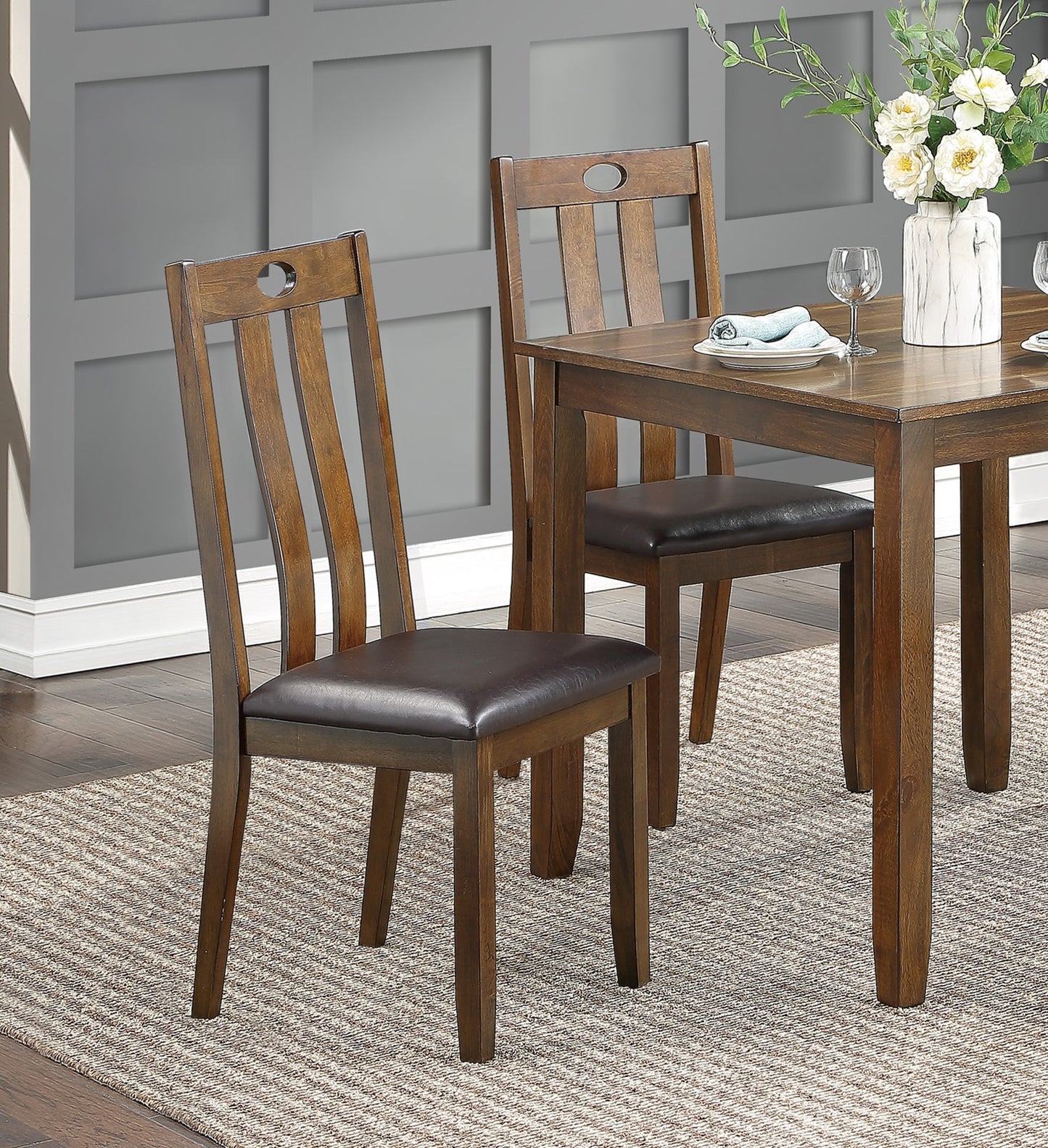 Wooden dining chair with upholstered dark brown seat and oval cutout detail