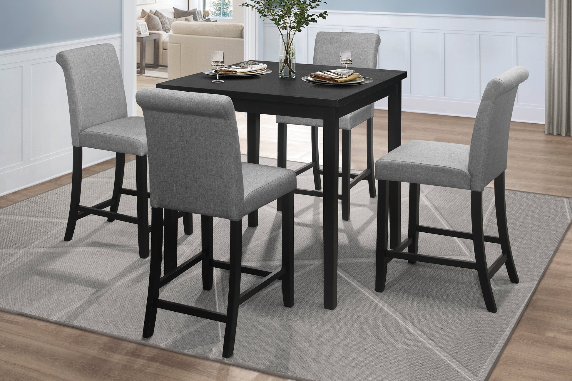 Black square counter height dining table with four grey upholstered stools